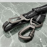 Happy Animalia black nylon dog seatbelt with adjustable elastic strap and metal clasp for car travel safety.