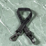 Happy Animalia black nylon adjustable dog seatbelt with elastic shock absorption and metal clips for car travel.